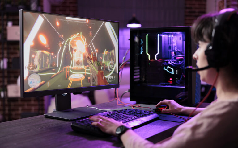 person with headset playing multiplayer video game in relaxed setting